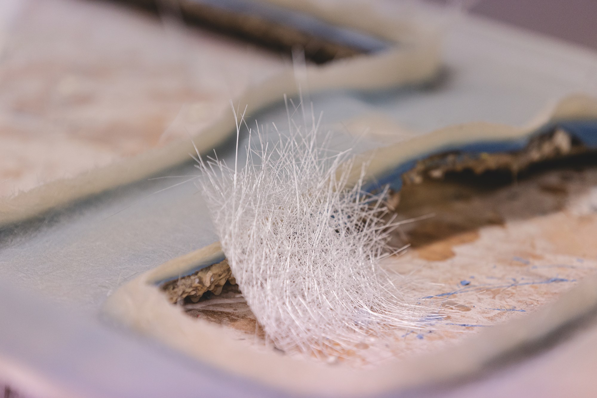 Close-up of glass fibres and a composite mould